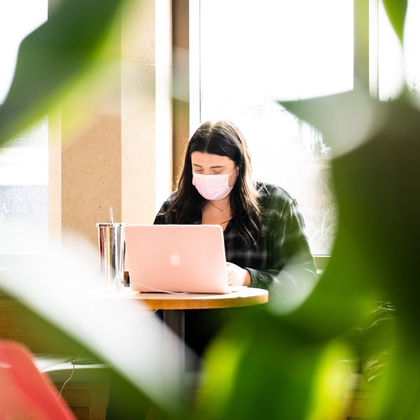 Student studying with mask on.