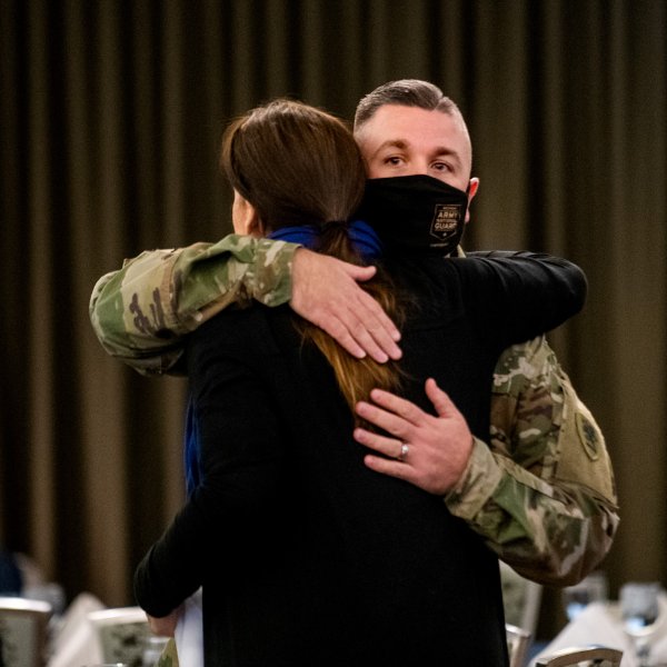 Two veterans hug at the GVSU Veterans Breakfast.