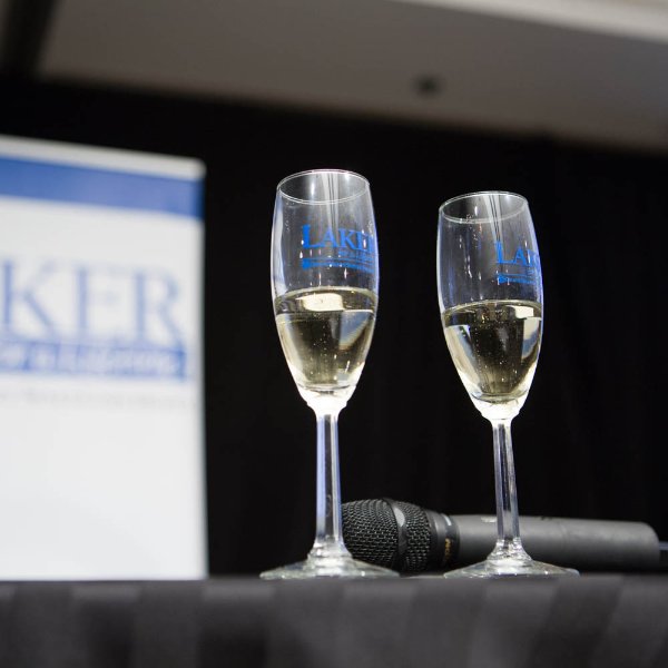 Two Champagne glasses that say "Laker for a Lifetime" sit on a table at a former toast to the graduating class.