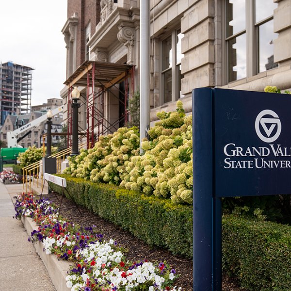 GVSU sign outside Detroit Center building; construction in background