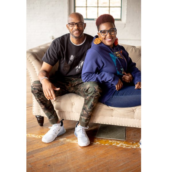 Shatawn and Nadia Brigham sitting on a couch; she is leaning on him