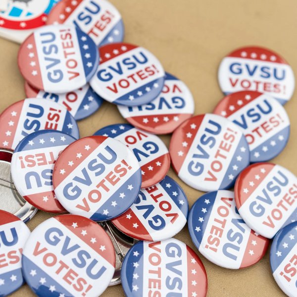 "GVSU Votes" buttons in a pile on a table