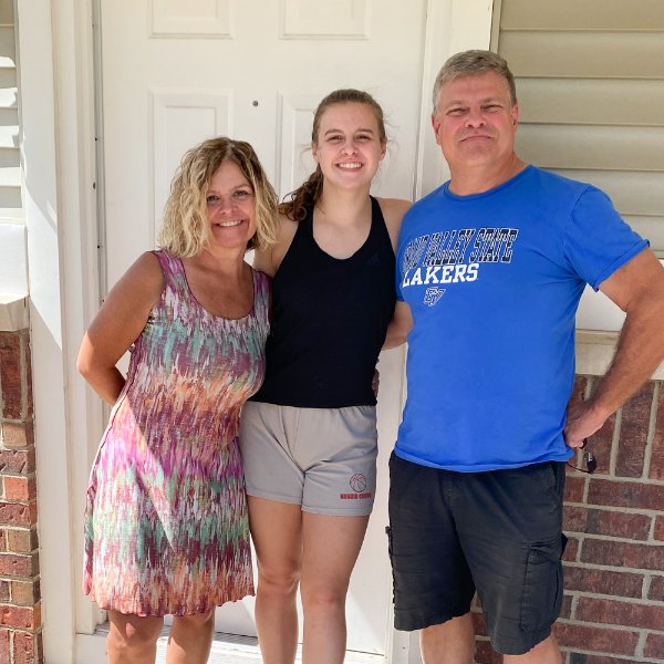 Linda, Paige and Chip Johnston are pictured in front of Paige's Laker Village apartment