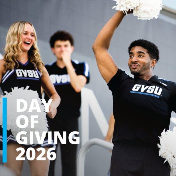 three cheerleaders in black GVSU uniforms with white pompoms, Day of Giving 2026