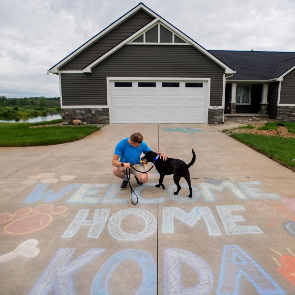 Officer Kelsey Sietsema and Koda, a black lab.