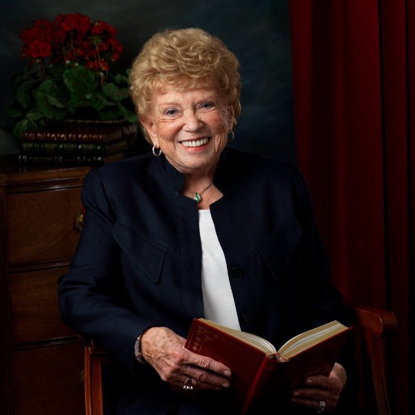 portrait of Joyce Wisner holding an open book