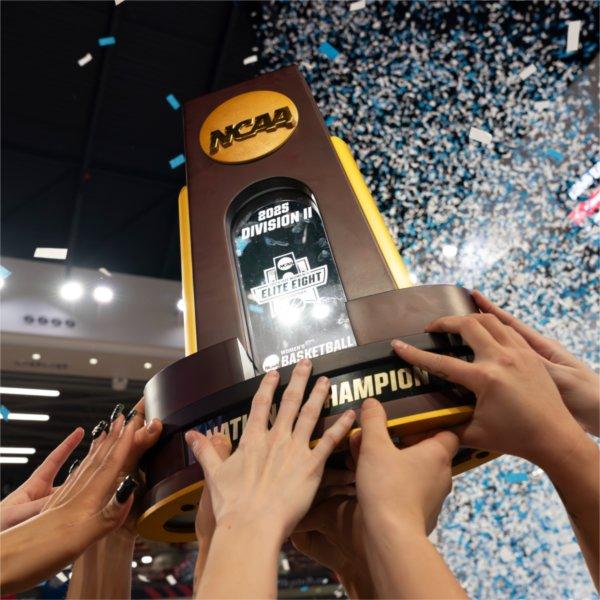 The GVSU Women's Basketball Team hoists the Division II Tournament Trophy
