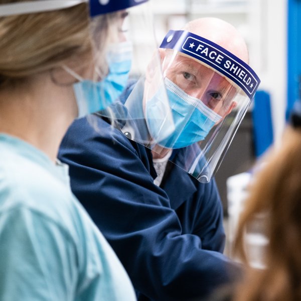 Steve Glass talks with a student in the exercise science lab.