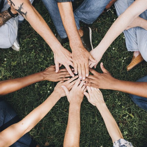 People putting hands in a circle