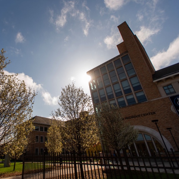 Sun shining behind Seidman College of Business building at Grand Valley State University