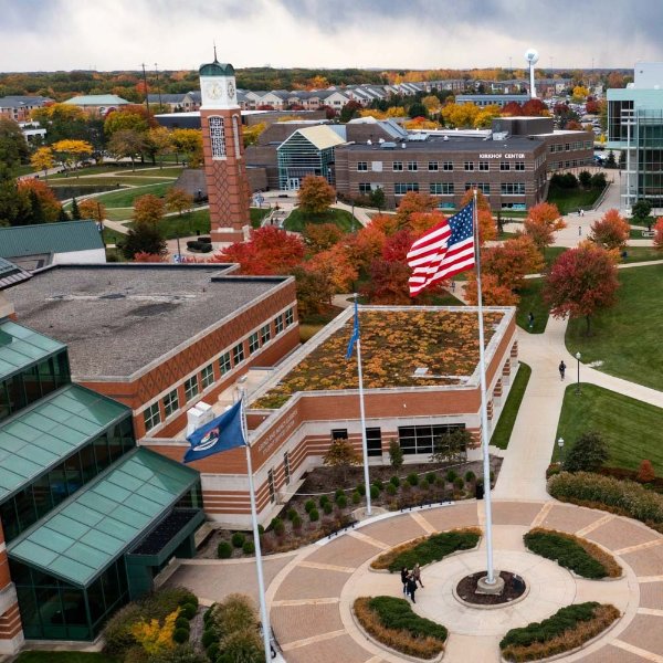 drone photo of Allendale Campus with flag circle at bottom right and carillon tower in upper left