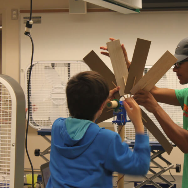 Campers work to discover the most efficient wind turbine.