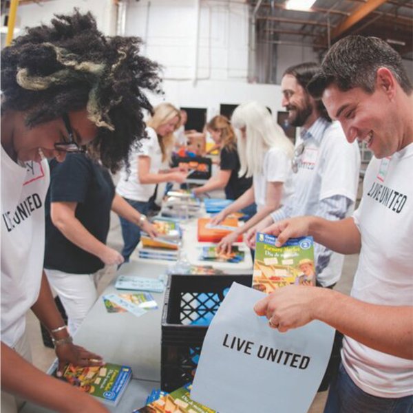 United Way volunteers prepare gift bags for students