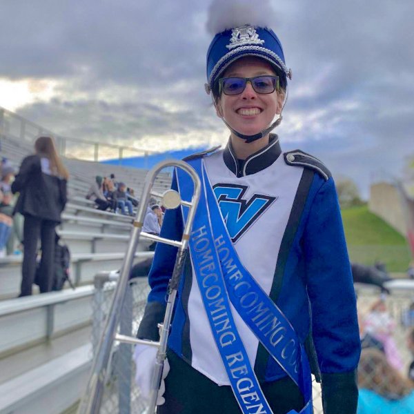 trombone player in Laker Marching Band uniform with homecoming regent sash over her shoulder