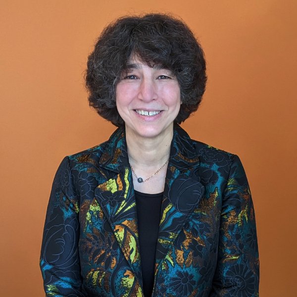 A person smiles in a posed photo.