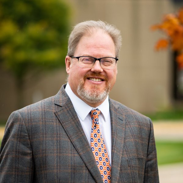 A person smiles in a portrait.