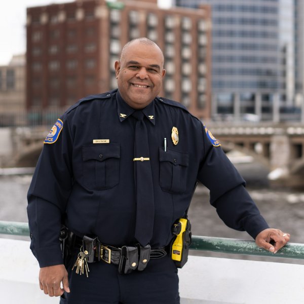 Chief Eric Payne stands in uniform on a bridge in Grand Rapids