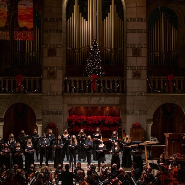 Singers and other musicians performs before at a church.