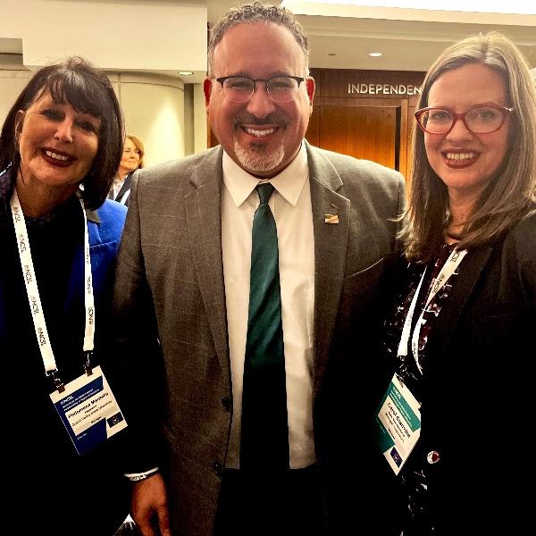 President Mantella, Education Secretary Miguel Cardona and Michigan Rep. Carol Glanville pose for a picture.