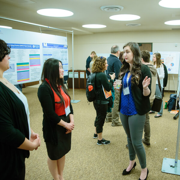 poster presentation with women talking