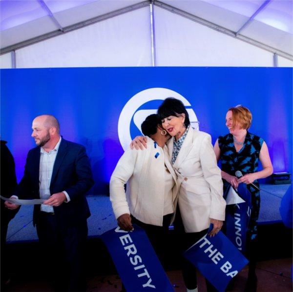 President Philomena V. Mantella, right, hugs La June Montgomery Tabron, president and CEO of the W.K. Kellogg Foundation, following the Battle Creek Innovation Hub ribbon cutting ceremony October 9.
