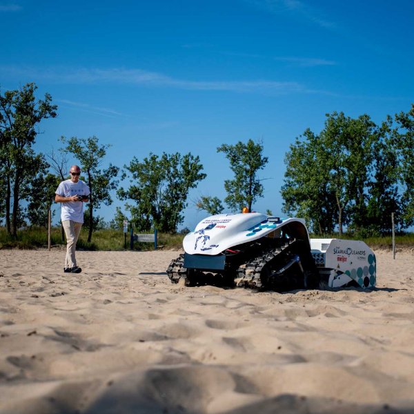A drone combs a beach for plastic and litter.