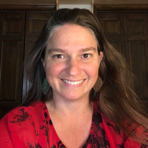 A person smiles in a posed photo.