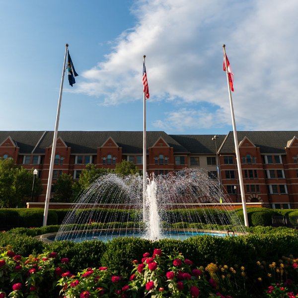 Three flags around a water fountain on the Pew Grand Rapids Campus.
