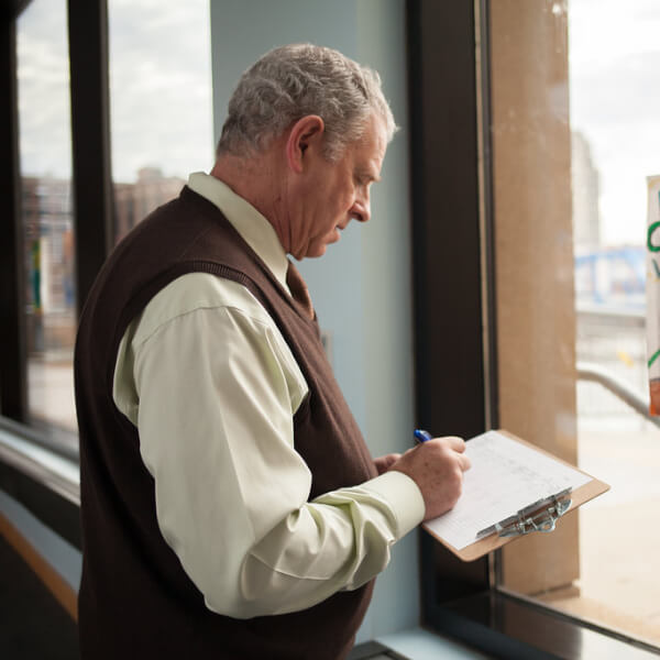 Barry Kanpol, dean of the College of Education, judges a poster contest for the River City Water Festival.