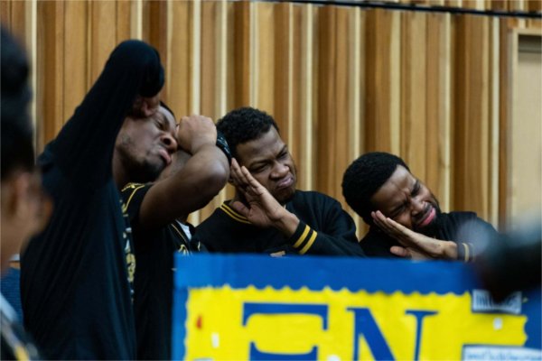 A student group poses for a photo by their table during the Blackout event.