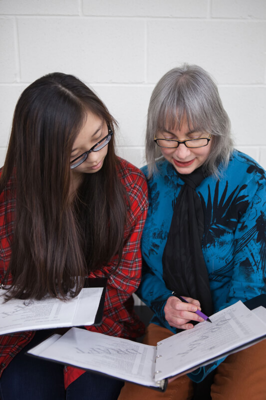 Diane Rayor, professor of classics, revising the "Helen" script with a student.