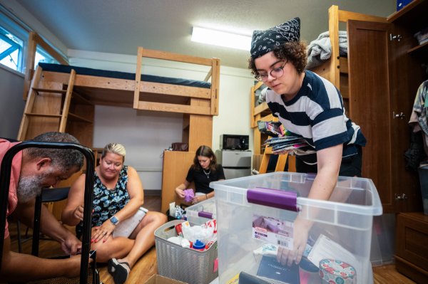  A college student with family members move into a university housing unit. 