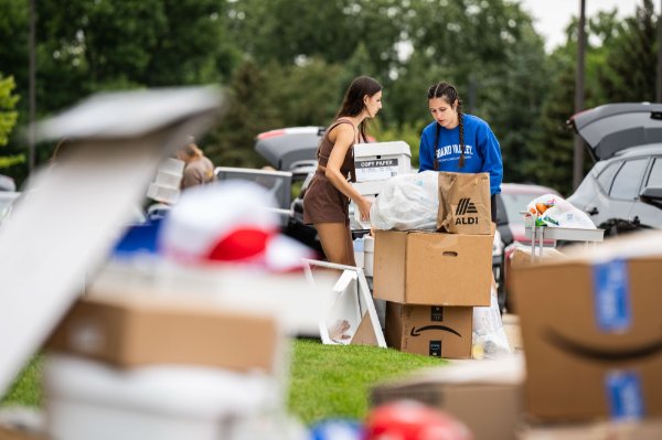 College students move boxes during move-in.  