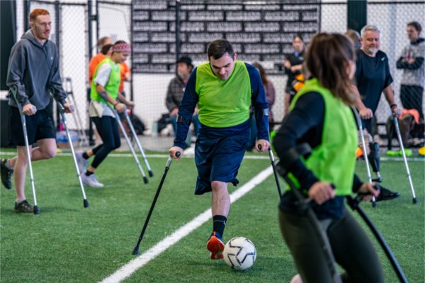 University of Michigan student Andrew Seelhoff plays soccer as part of an amputee soccer clinic at the Grand Rapids Soccer Society on February 8.