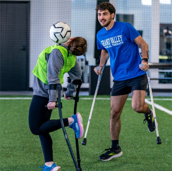 Recreational therapy student Emily Gray, left, plays soccer with physical therapy student Jeremy Hicks as part of an amputee soccer clinic at the Grand Rapids Soccer Society on February 8. 