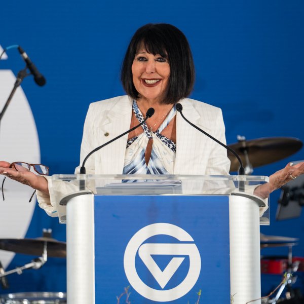 President Mantella speaking with faculty and staff at event.