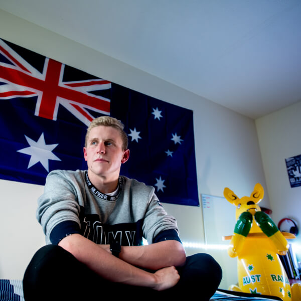 man sitting in bedroom
