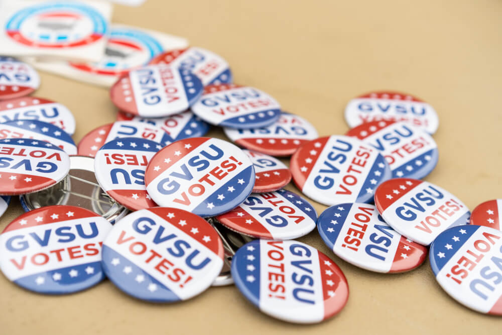 A pile of buttons that read "GVSU Votes!"