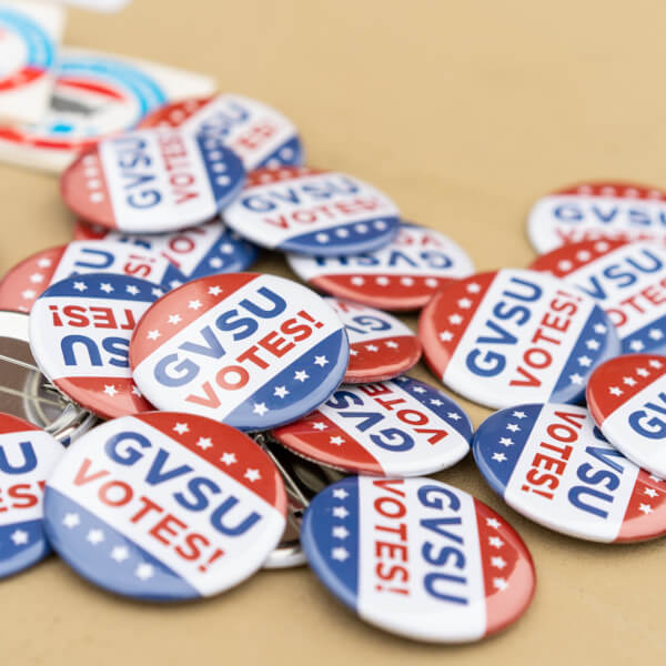 A pile of buttons that read "GVSU Votes!"
