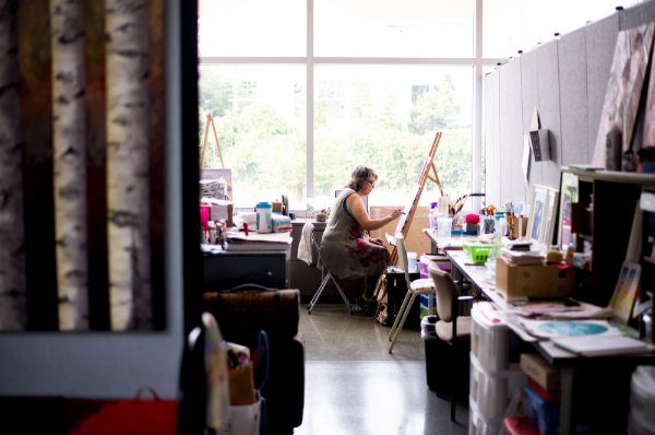 Lynn Frisinger Stribley paints in her studio space that she rents from the GVSU Muskegon Innovation Hub.