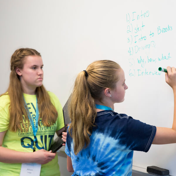 two students at whiteboard