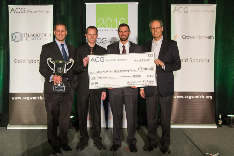 From left: MBA students Robert Walmsley, Brent Pelishek and Russ Duba, and Paul Mudde, associate professor of management.