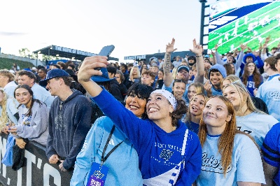 President Mantella poses for a selfie with students during a Laker football game at Lubbers Stadium.