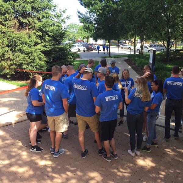 GVSU Police Academy students continued a tradition of community service by distributing LED light bulbs and crime prevention brochures to residents in Grand Rapids.