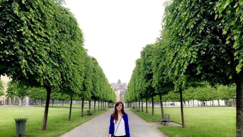 Amber Sackett standing near line of trees