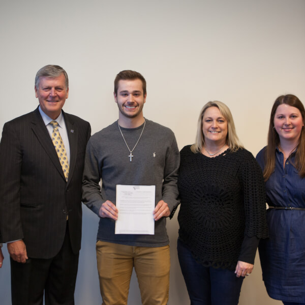 Trevor Fairfield, center, with President Haas and family. 