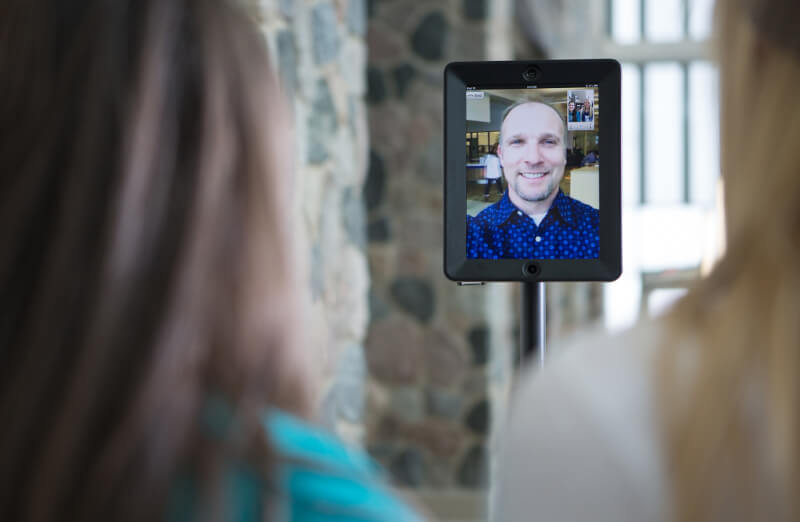 iPad with face of Eric Kunnen mounted on a swivl robot