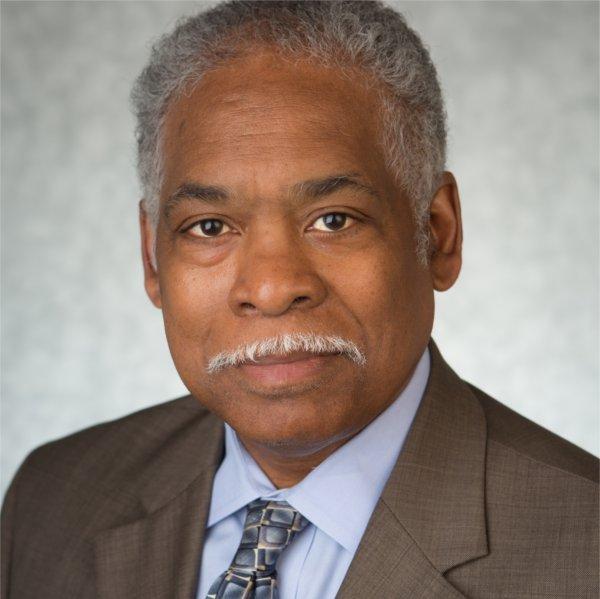 James Moyer headshot in suit, light shirt and tie