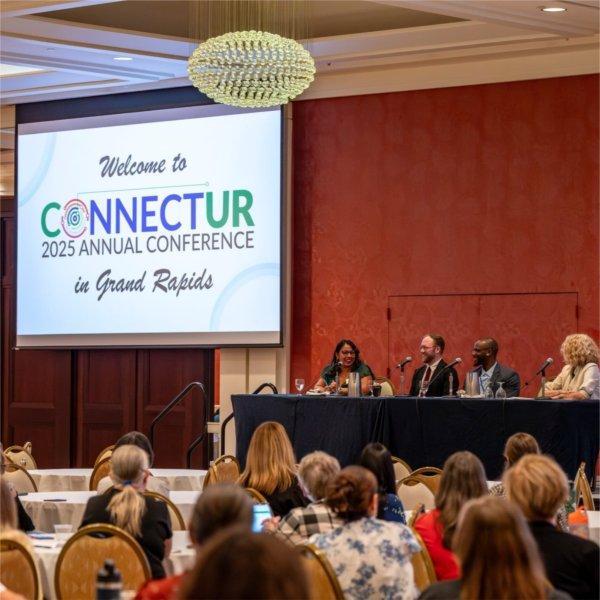 A dais featuring Grand Valley graduates discuss their experience with undergraduate research