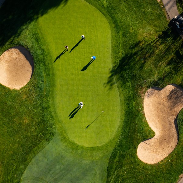 Aerial photograph of golfers putting on a green at The Meadows Golf Course
